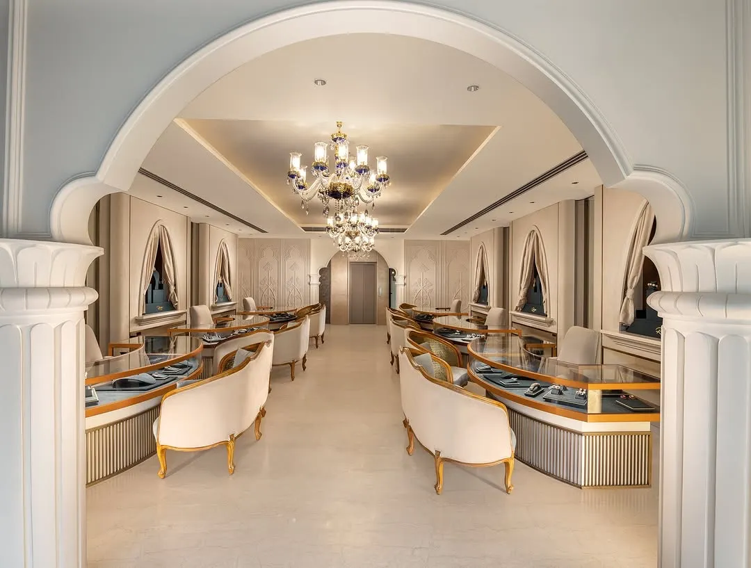 I designed this luxury jewellery showroom to be a masterpiece of classic elegance. The interior view showcases bespoke curved seating, grand chandeliers, and arched entryways that frame the space, creating an exclusive and sophisticated environment for a high-end retail experience.