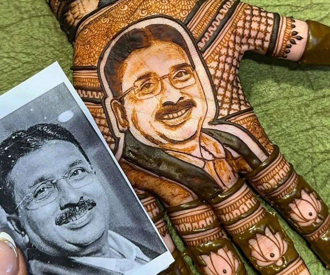 This design is one of my favorites and holds a special place in my heart. The bride wanted a portrait of her father on her palm with the words 'Papa meri jaan', and creating this emotional piece was an honor.
