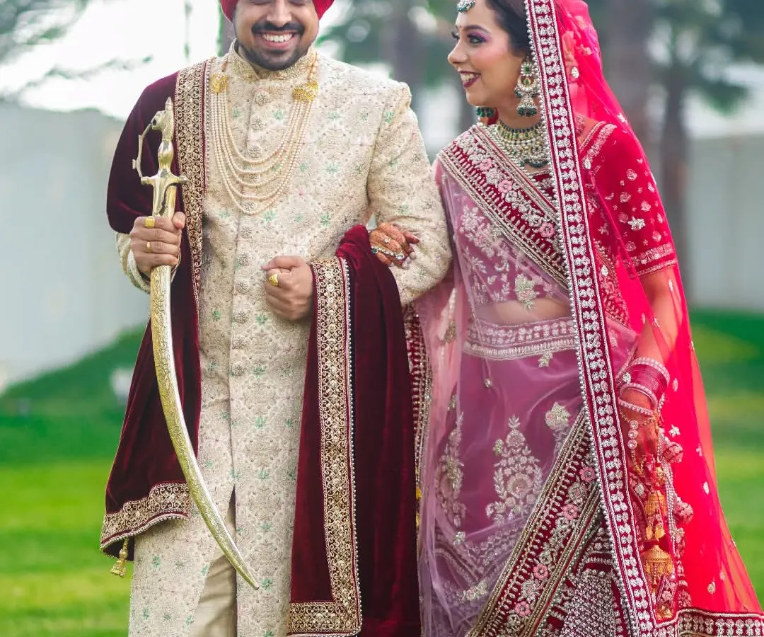 A candid moment of pure happiness between a beautiful Sikh couple. We believe the best shots are the unposed ones, capturing the genuine smiles and laughter that make your wedding day unique. This photo reflects our classic and vibrant wedding photography style.