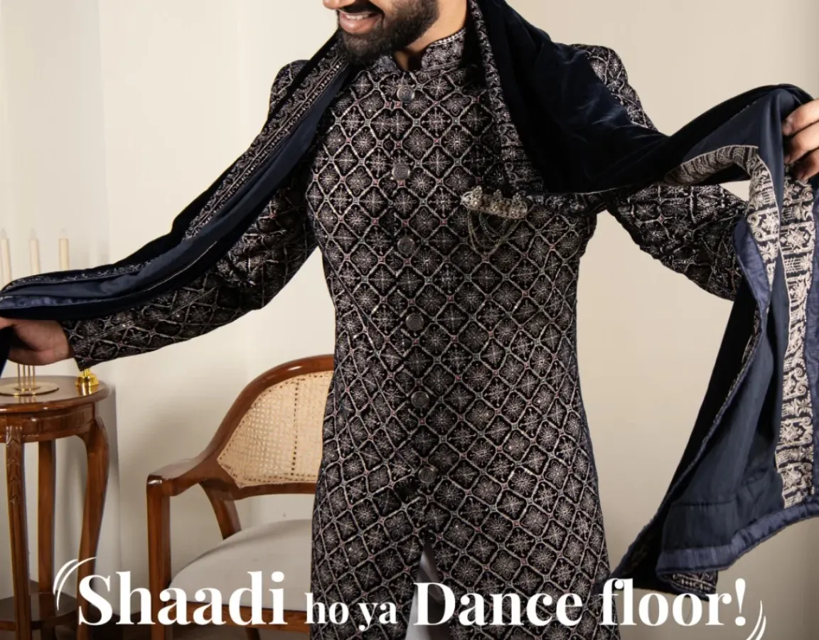 Shaadi ho ya dance floor, your entry should always make a statement. This navy blue patterned sherwani is crafted for grand moments, ensuring you are the center of attention. The rich fabric and sharp cut offer both royal style and complete comfort for celebrating.