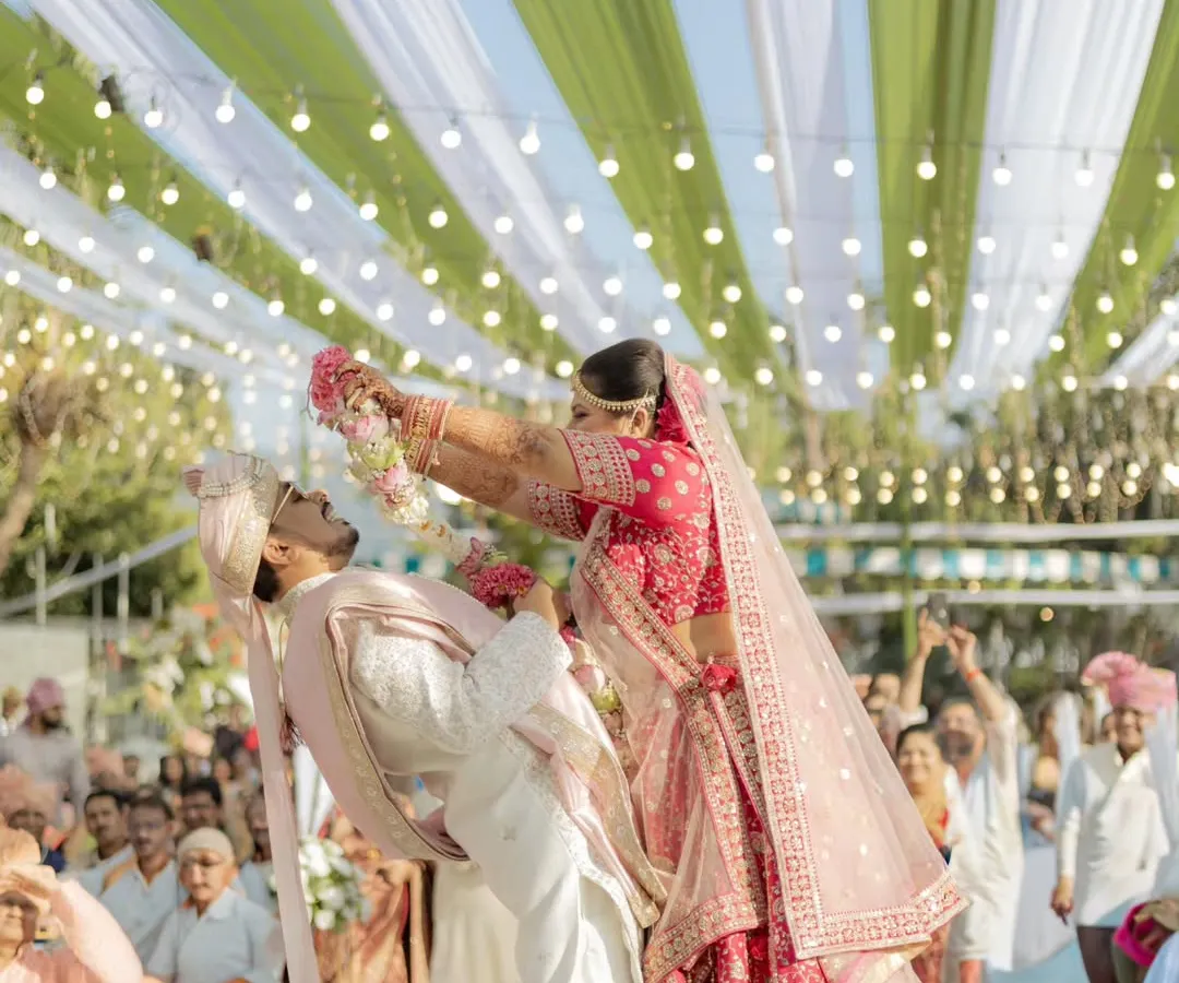 The varmala isn't just a ritual; it's a playful battle of love. I'm always ready to capture these fun, unscripted moments that show your unique chemistry and the pure joy of your shaadi.