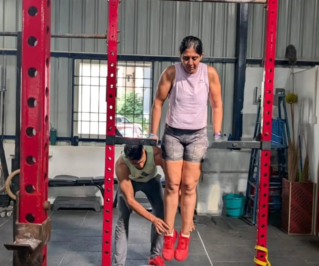 My coaching philosophy is simple: mechanics, consistency, then intensity. Here, I'm providing hands on support to help a client master the mechanics of a bar dip, ensuring she builds strength on a solid foundation of proper form.