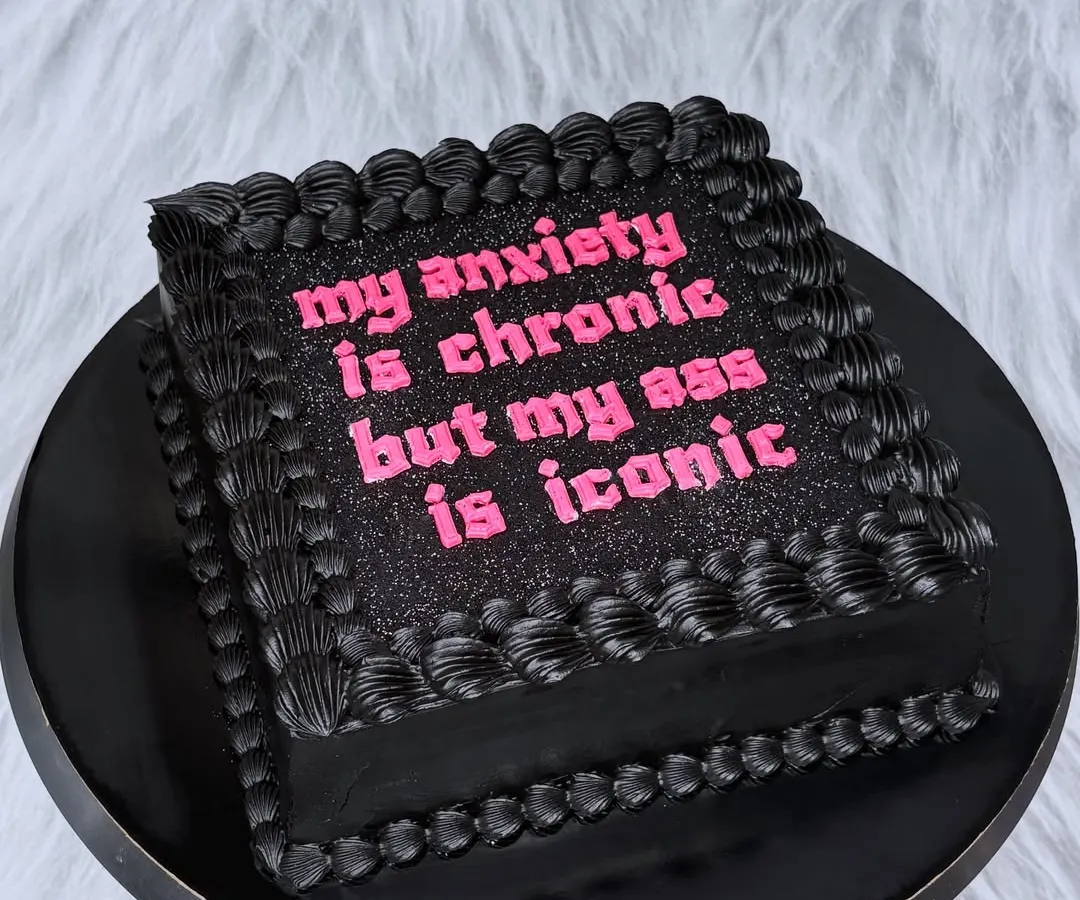 This is for everyone who knows their worth. A black buttercream cake with glittery pink text that says it all: "my anxiety is chronic but my ass is iconic". Let's celebrate you, your confidence, and your iconic self with a cake that's just as bold.