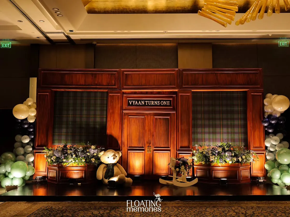 This wide view of our 'Polo Club' themed first birthday showcases our ability to transform a venue with large-scale, custom backdrops. The rich wood facade, classic tartan, and soft balloon arrangements create a sophisticated yet playful world for little ones and their families.