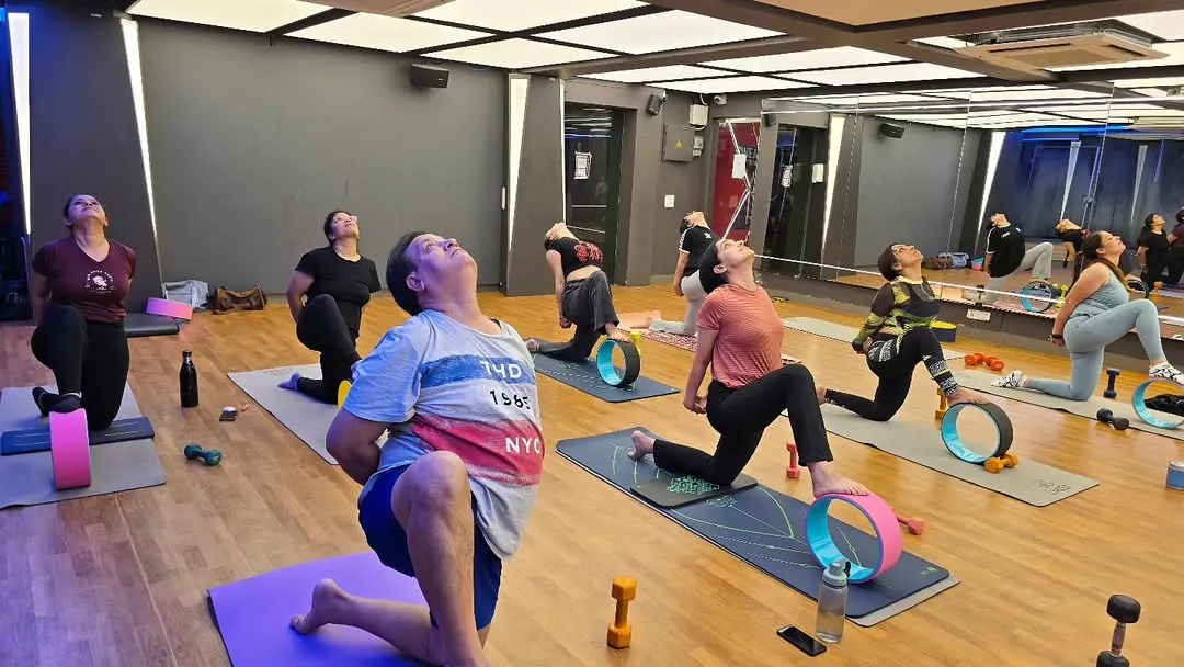 In my studio classes, we often use props like the yoga wheel to explore poses more deeply and safely. Here, my students are in a heart opening backbend, using the wheel to support their spine, enhance flexibility, and build core strength.