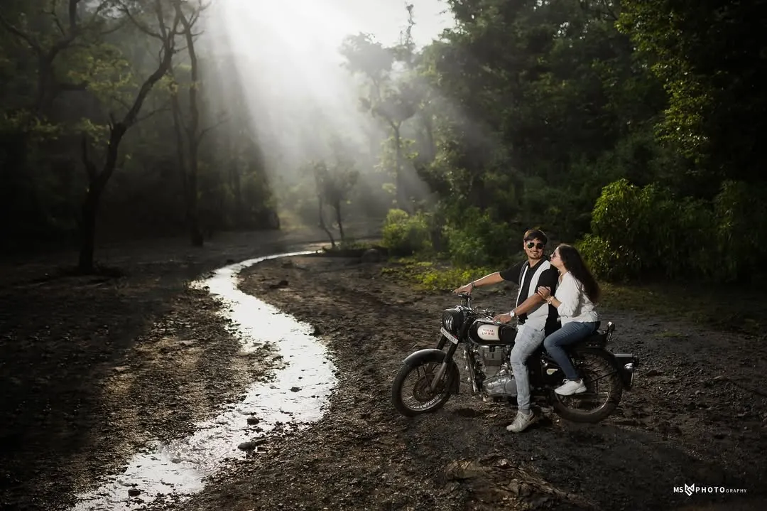 I love creating a moody, cinematic feel. Here, we used the misty forest roads of Uttarakhand and a classic motorcycle to capture a moment of adventure and romance, with dramatic light rays breaking through the trees.