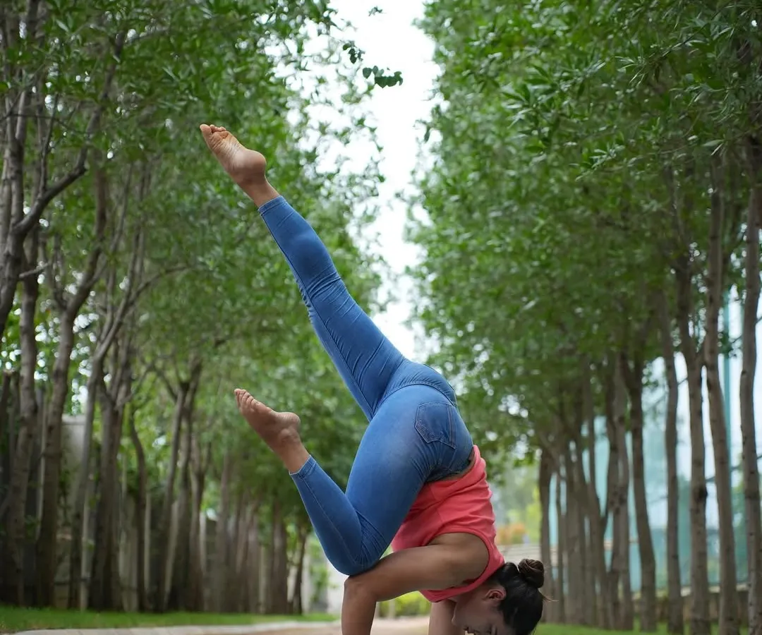 My own practice is the foundation of my teaching. Here, I'm in a variation of Pincha Mayurasana, or forearm stand, focusing on core control and shoulder stability. Mastering advanced asanas myself allows me to guide you safely and effectively toward your own goals.