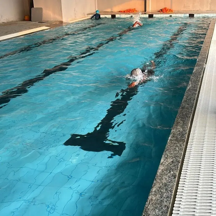 A swimmer enjoying a focused lap session in our clean, well-maintained 25-meter indoor pool. This is the perfect environment for a consistent workout, regardless of the weather.