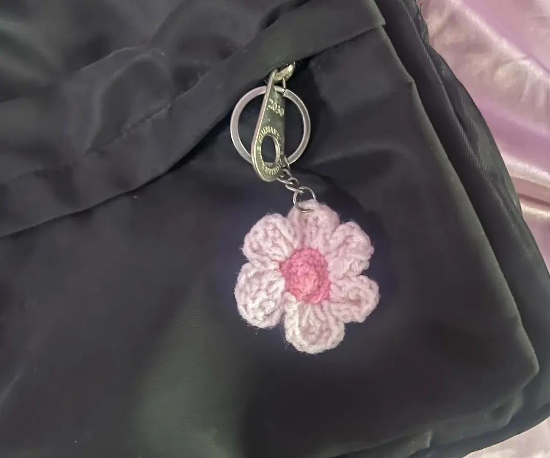 Here’s my two-toned flower keychain on a backpack. It adds such a cute, coquette vibe to a simple black bag.
