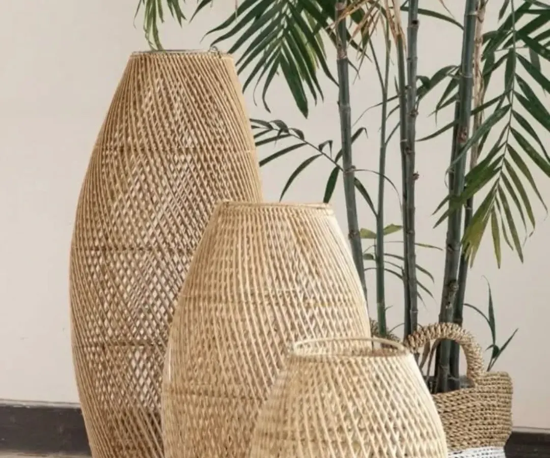 Add a touch of natural elegance to your home with our set of three handwoven rattan and bamboo floor vases. Their intricate texture and organic shape make them a stunning focal point, perfect for displaying dried botanicals or standing alone as sculptural art.
