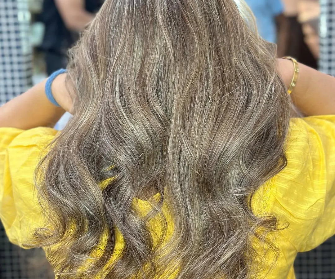 A perfect example of ash blonde highlights on Indian hair. I carefully place each foil to create this beautiful, multi-dimensional effect that looks both modern and sophisticated. The cool tones blend seamlessly for a high-end finish.