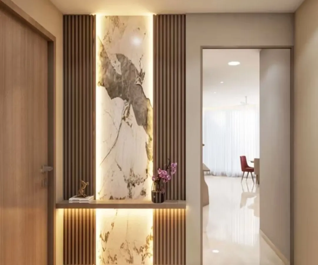 See how beautifully our materials come together in a real home. This entryway uses a combination of a backlit marble-finish tile and wooden fluted wall panels to create a warm, luxurious welcome. We can help you design a similar look for your space.