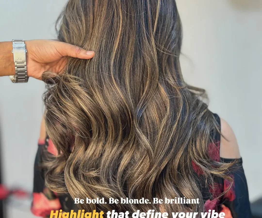 Be bold, be brilliant. We created these beautiful blonde highlights using a balayage technique for a seamless, sun-kissed effect. The soft waves really make the different tones pop.