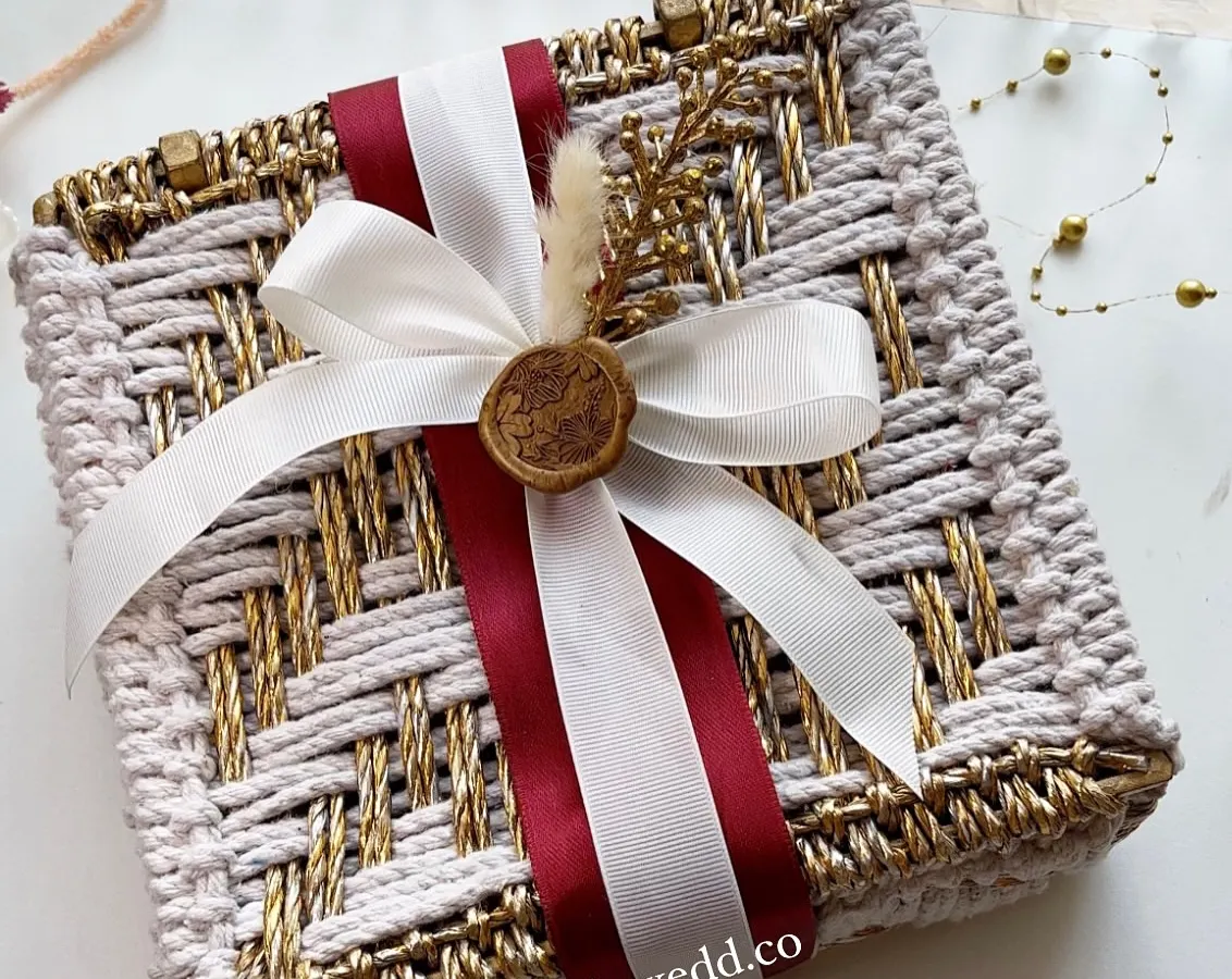 We design wedding invitations that set the tone for your entire celebration. This handcrafted woven box, finished with a custom wax seal, moves beyond a simple card to become a beautiful keepsake and the first taste of your wedding's aesthetic.