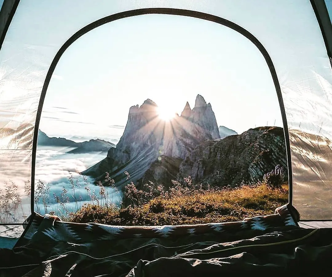 Imagine waking up, unzipping your tent, and being greeted by this. The sun breaking through the peaks, a sea of clouds below you. I find these special hillside spots so you can have a front-row seat to Mother Nature's morning spectacle.