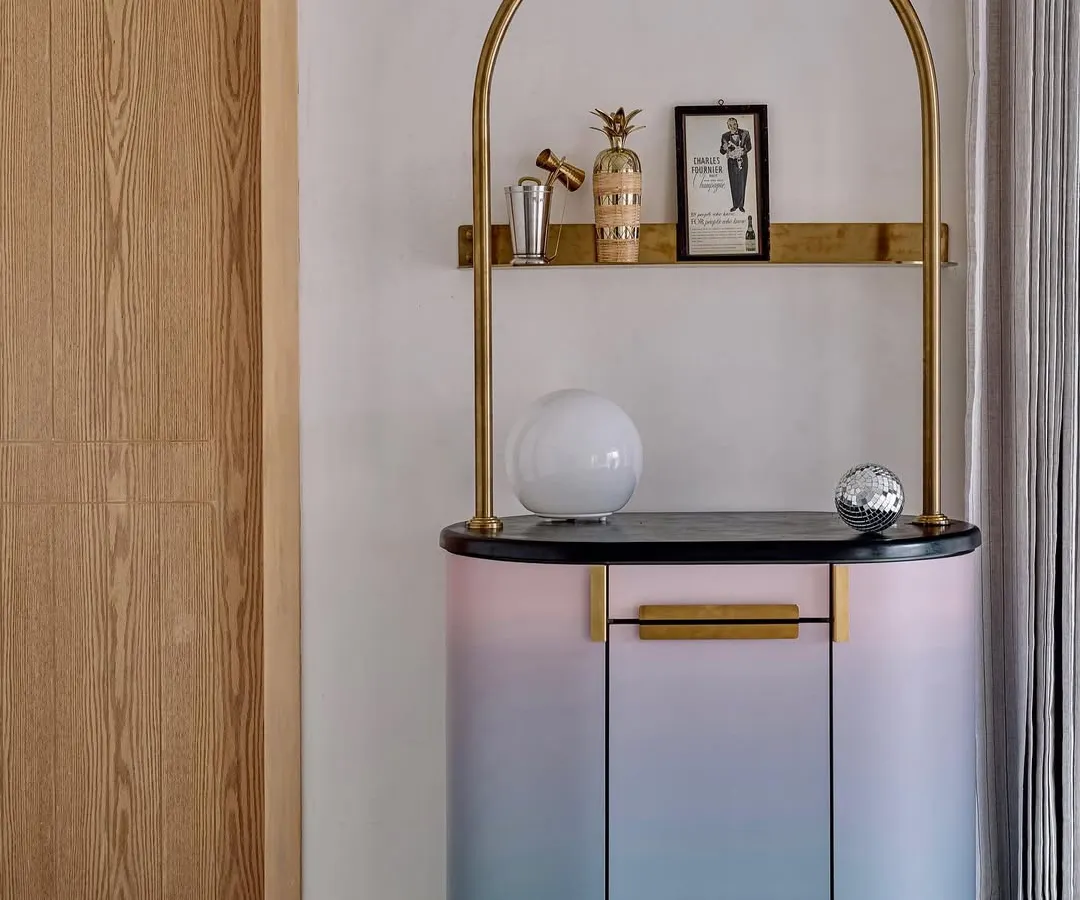 The Gradient Bar, a collaboration with Arjunvir Gujral, brings a playful yet glamorous energy to any space. Its unique gradient finish and delicate gold-arched frame create an alluring focal point for entertaining and celebration.