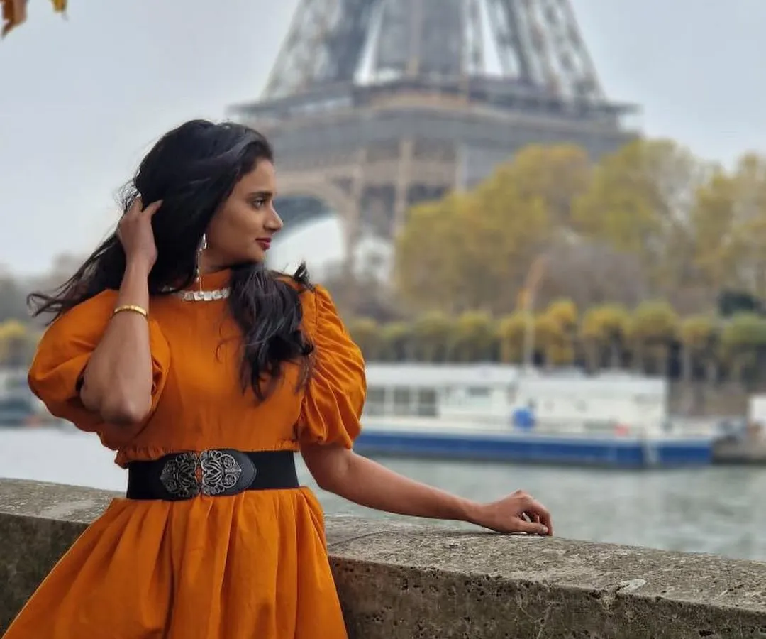 We love seeing our creations travel the world. Here is our wonderful client looking effortlessly chic in our custom orange puff-sleeve dress against the iconic backdrop of the Eiffel Tower in Paris. This is the perfect example of our versatile vacation wear.