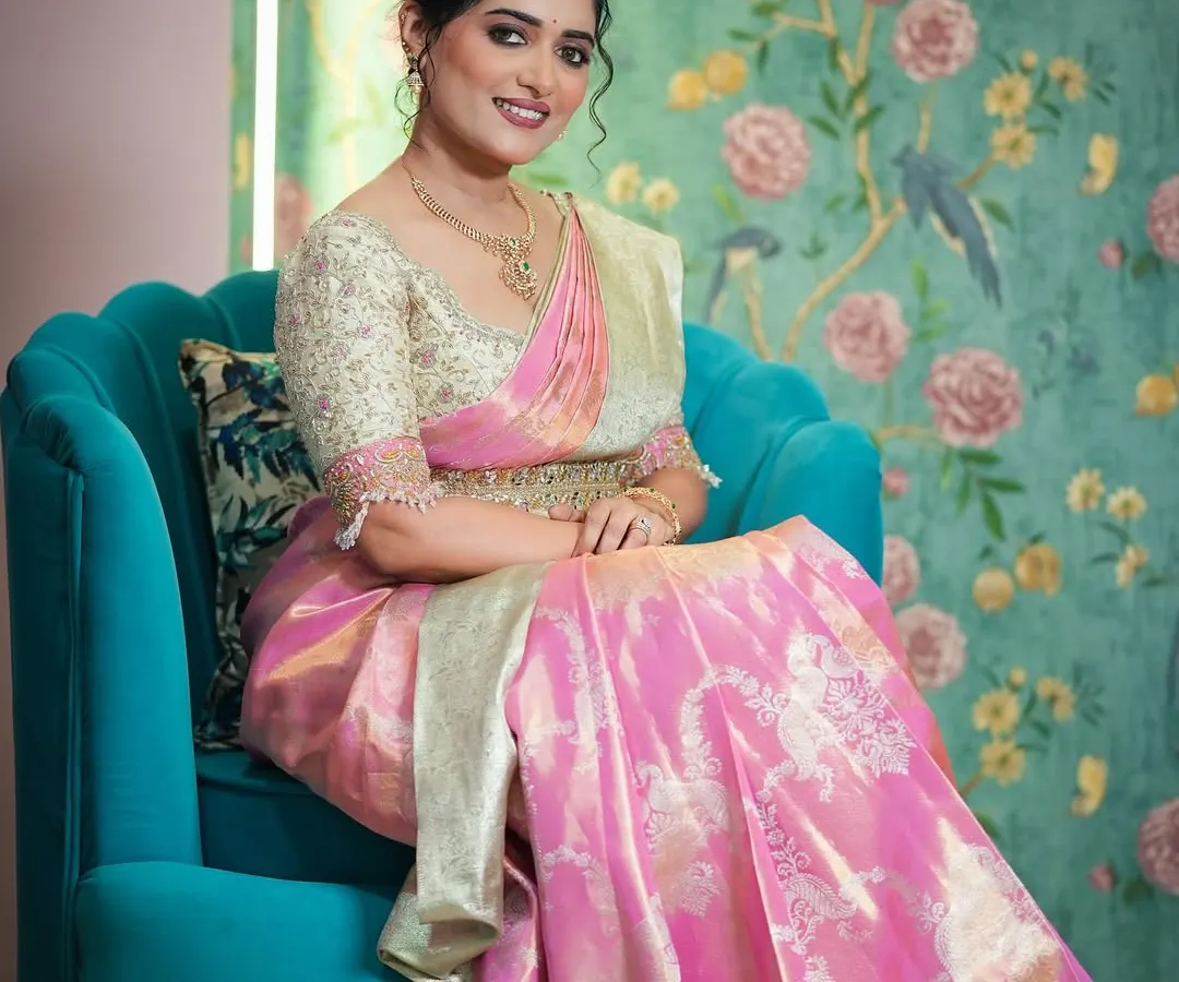 For this muhurtam look, I created a stunning Langa Voni, or half saree, in a vibrant pink brocade. The heavily embroidered cream blouse adds a touch of regal elegance, perfect for a bride's special day.