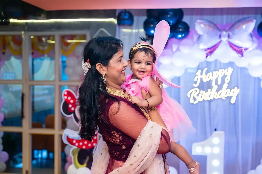 A mother's joy is so pure, especially on her baby's first birthday. This candid moment, with the little one dressed as a fairy, is exactly the kind of precious memory I aim to freeze in time during birthday celebrations.
