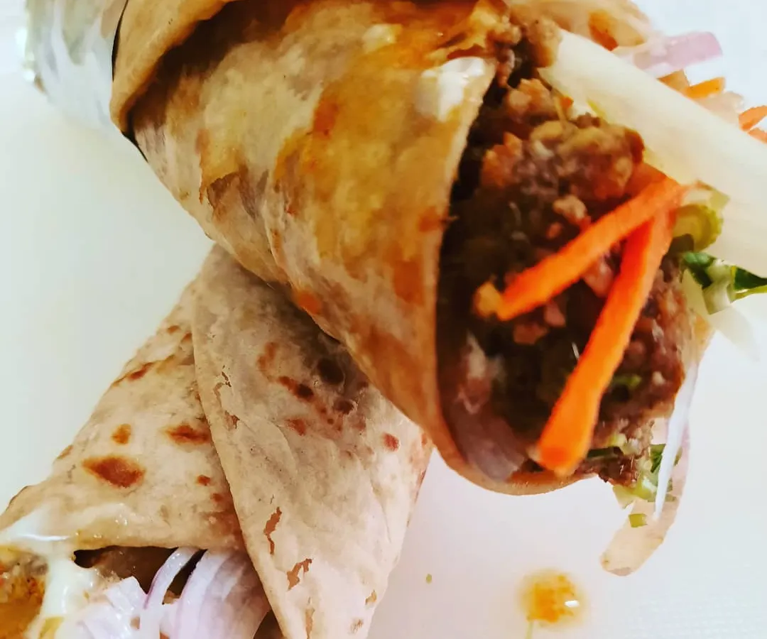 Inspired by the old Irani cafes of Bombay, this is my take on the classic Chicken Kheema Roll. I use finely minced chicken slow-cooked with cinnamon, cloves, and other warm spices, then pack it into a soft, handmade paratha with fresh onions and carrots for a bit of crunch.