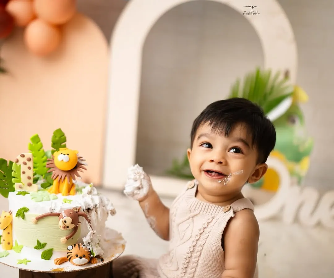 The pure, unfiltered joy of a first birthday cake smash. This is what it's all about: sweet smiles, messy fingers, and a memory that will be cherished long after the cake is gone.