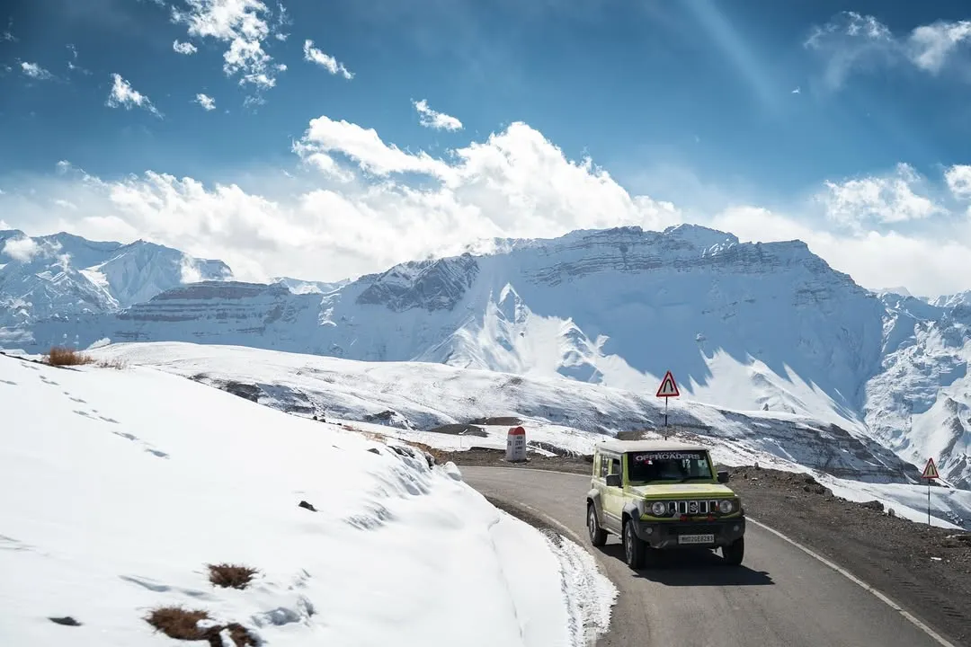 An off-road vehicle navigates a winding road in the snow-covered expanse of Spiti Valley. This drone shot captures the scale of the Himalayas and the spirit of adventure that drives me to explore these remote landscapes.