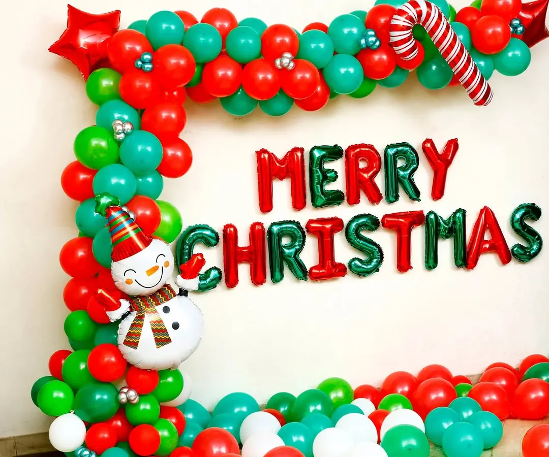 Here is a close-up of a custom Christmas photo booth frame I created. It includes 'Merry Christmas' foil lettering, a cheerful snowman, and a classic red, green, and white balloon arrangement, perfect for team photos and office parties.
