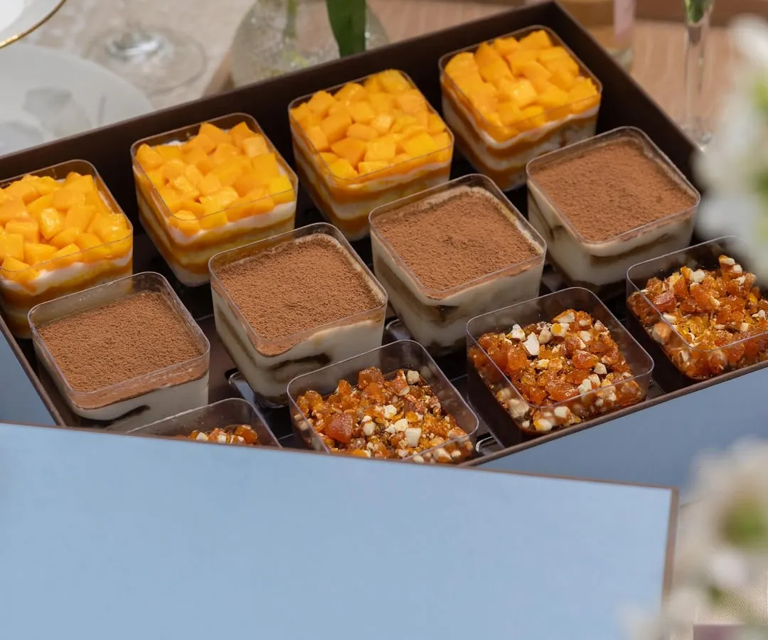 This is what happiness in a box looks like. Our assorted dessert cup box features a curated selection of our most popular trifles, including the fresh Mango & Cream Cheese, the classic Tiramisu, and the indulgent Chocolate & Caramel. It's a perfect centerpiece for a party or a luxurious gift.