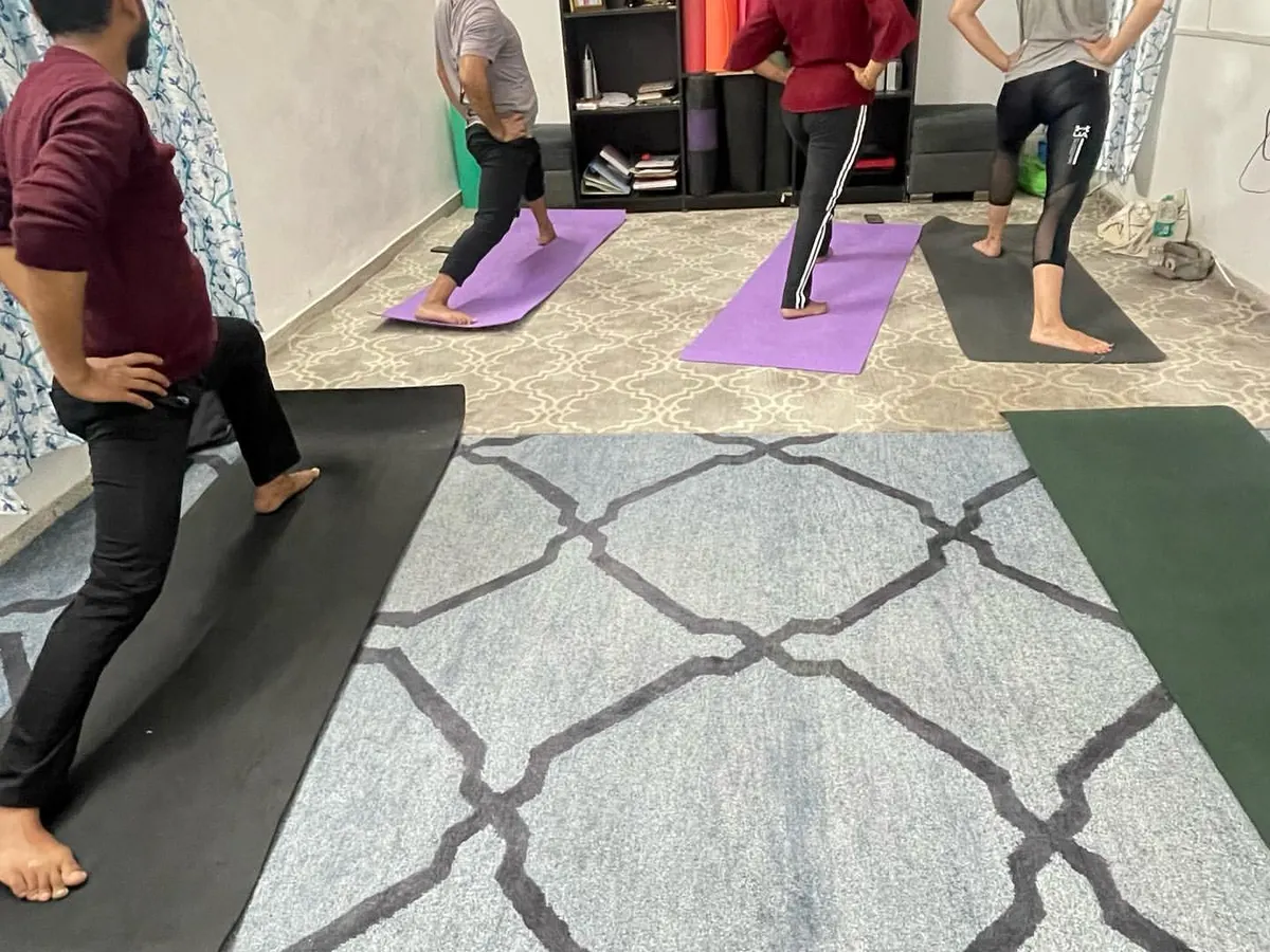 A snapshot from one of my group classes in Delhi. I guide a small batch of students through Virabhadrasana I, or Warrior I pose. I focus on correct alignment for each person to ensure they build strength safely and effectively.