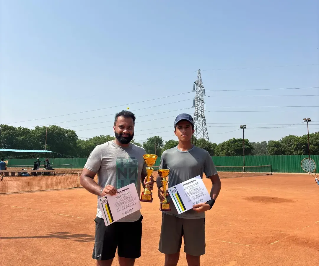 Celebrating the winner and finalist of the Delhi State Tennis Premier League for men. This image shows two of our top adult competitors on the clay court, holding their trophies and certificates after a hard-fought match.