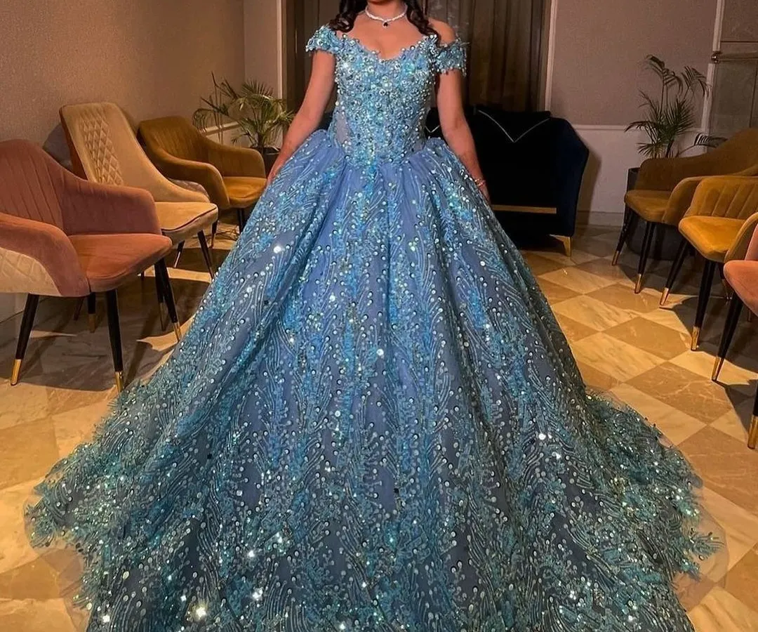Here is one of my clients looking like a true princess in a fully embellished ice-blue ball gown. This rental gown is perfect for an engagement or reception, featuring off-shoulder sleeves and a voluminous skirt that sparkles with every movement.