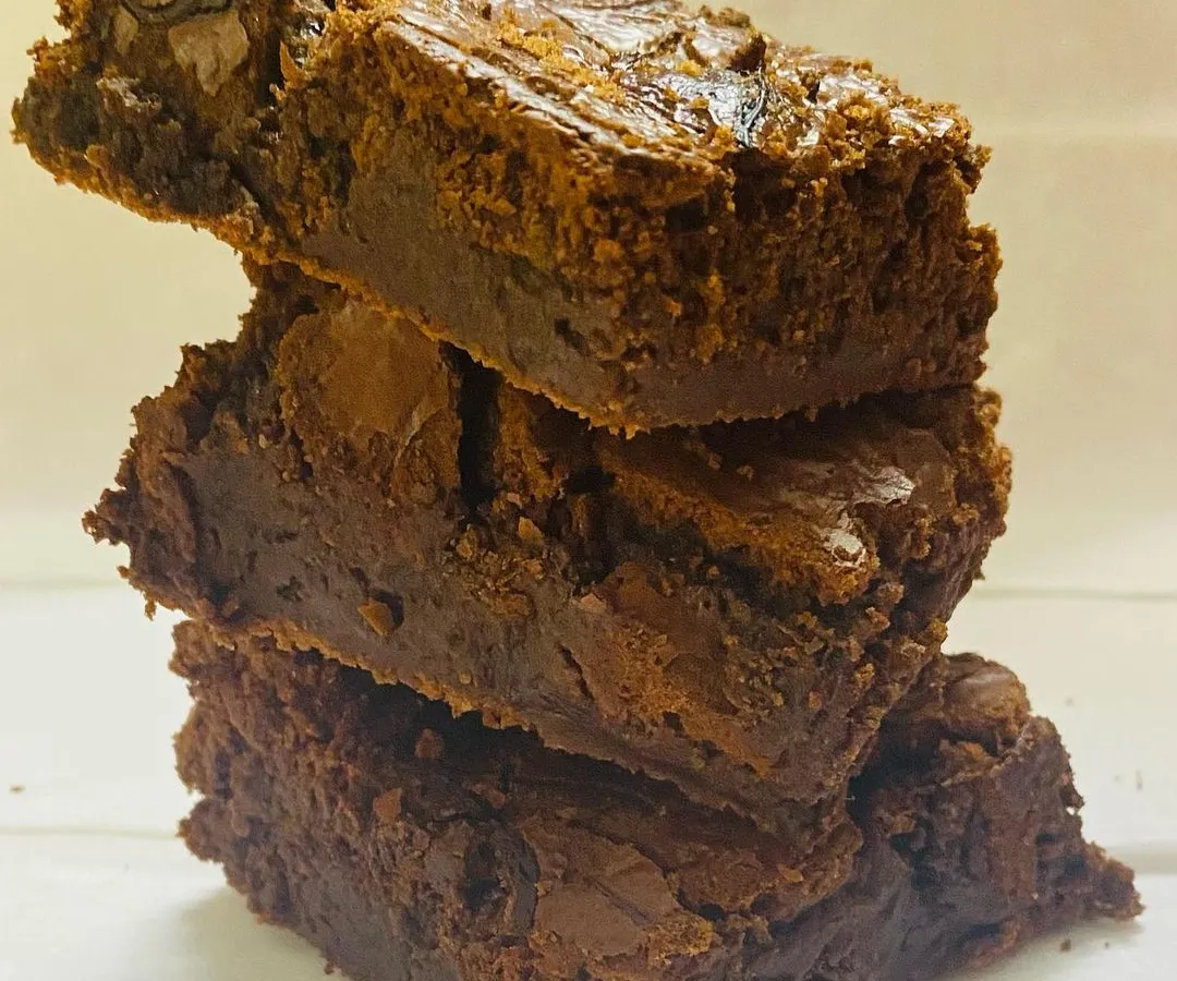 A tempting stack of my ultra-fudgy chocolate brownies. You can see the perfect crackly top and the dense, moist center that makes them a must-try for any chocolate lover.