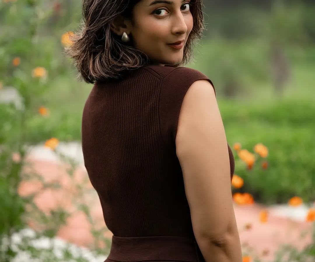 An outdoor portrait of a model in a chic brown dress, showcasing our ability to use natural light and environments to create compelling fashion images that feel both elegant and authentic.