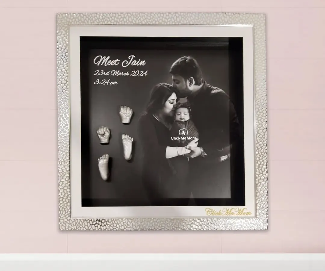 For a modern and heartfelt tribute, I can combine your family's first portrait with the delicate silver casts of your baby’s hands and feet. This design features a stunning silver textured frame and a classic black and white photograph, creating a sophisticated piece of art for your home.
