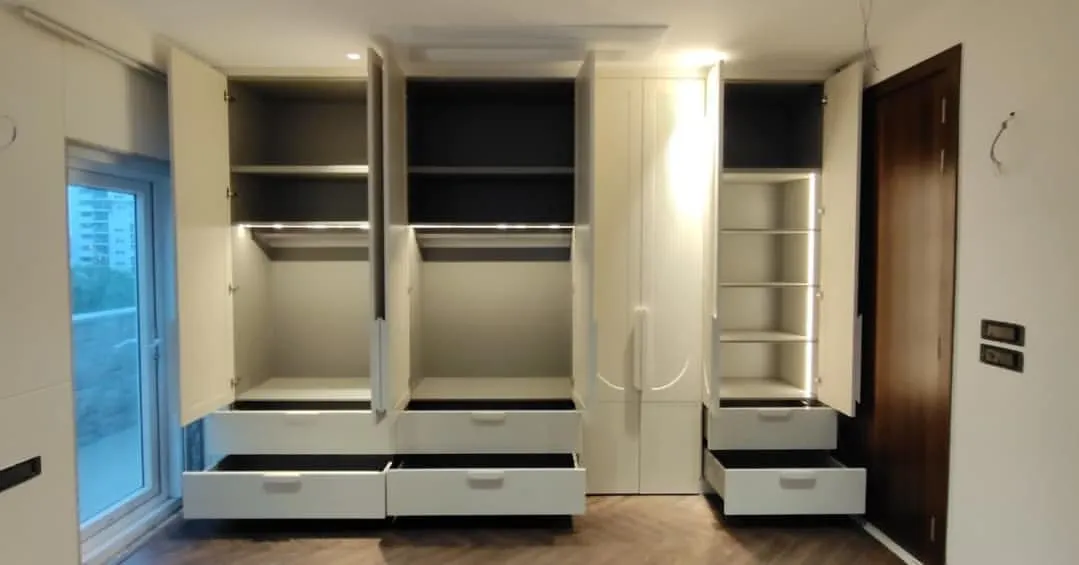 The interior of this wardrobe is just as impressive as its exterior. We incorporated sensor-activated LED strip lighting, multiple drawers for small items, and a mix of hanging spaces and adjustable shelves for complete organization.