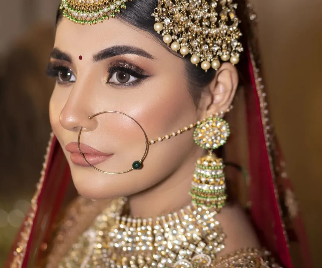 A close-up of my Heritage Bride look. I focused on creating sharp, defined features with bold winged eyeliner and a matte nude lip, letting the magnificent Polki and pearl jewellery shine. This is for the bride who wants to look like pure royalty.