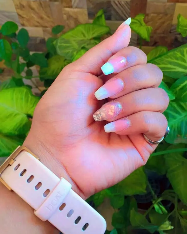 This is the amazing result from one of my students. They created this beautiful ombre nail set with a French tip effect and an accent nail featuring delicate encapsulated dry flowers and glitter.
