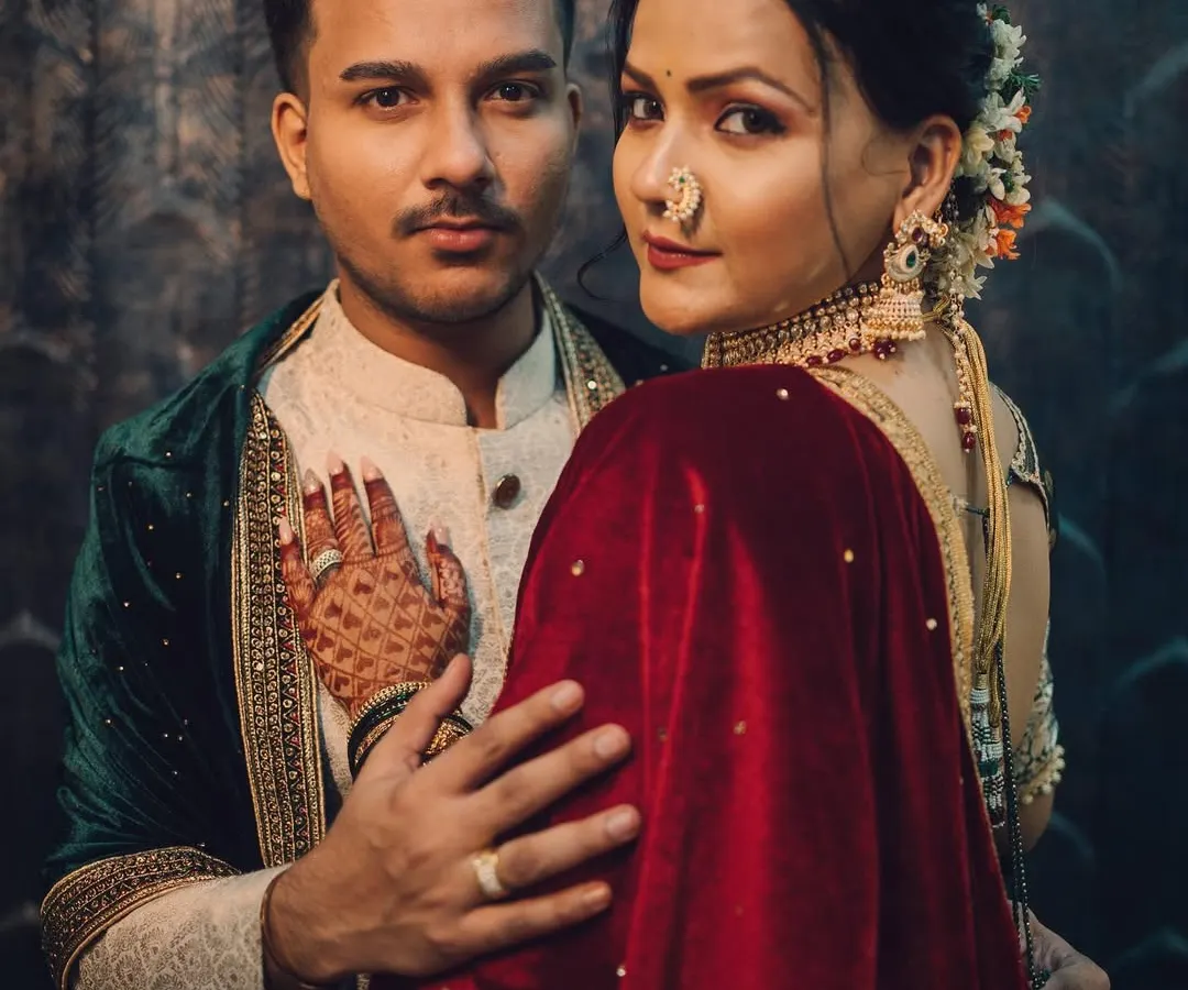 A powerful and intimate royal-themed couple portrait, showcasing a deep connection with moody, cinematic lighting and rich, traditional attire.