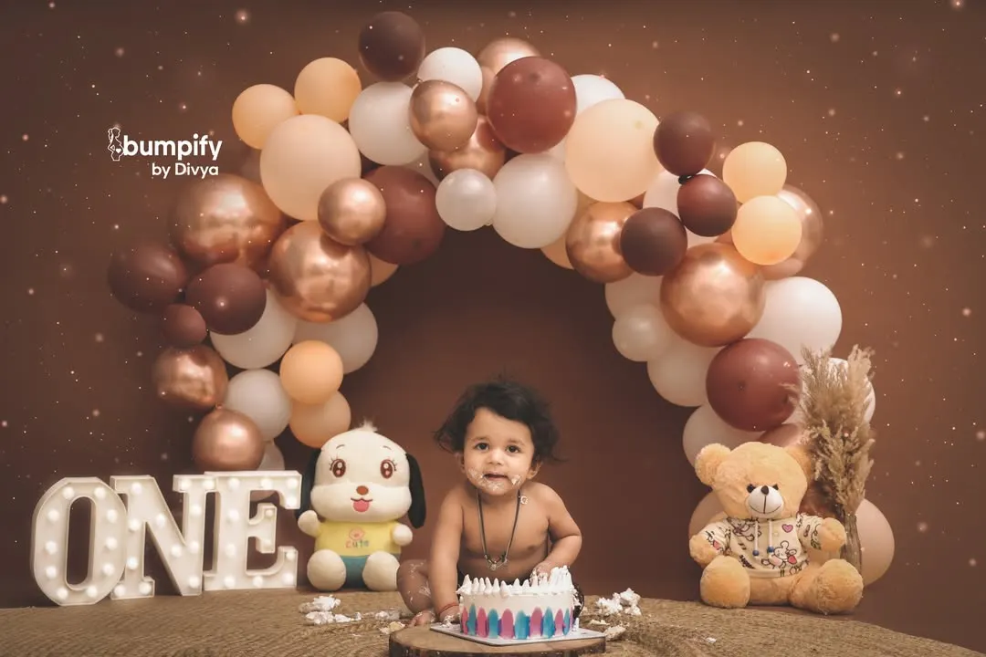 Turning one is a huge milestone, and we celebrate it with a bang. This cake smash session is set against a beautiful balloon arch, capturing the pure joy and curiosity of your little one's first taste of birthday cake.