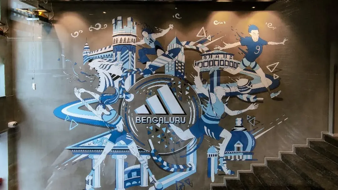For the new Adidas store in Bangalore, we created a dynamic mural that captures the city's spirit and the brand's energy. This custom wall art blends local Bengaluru landmarks with the motion of sport, creating a powerful statement piece for the retail space.