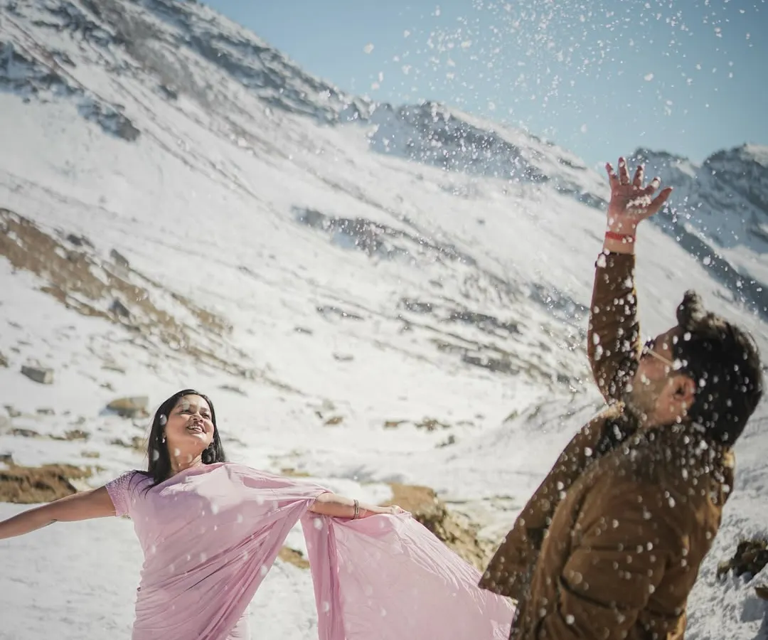 Capturing the pure, unscripted joy of a playful moment in the snow. This is for couples who want their pre-wedding shoot in Manali to be full of laughter and spontaneous fun.
