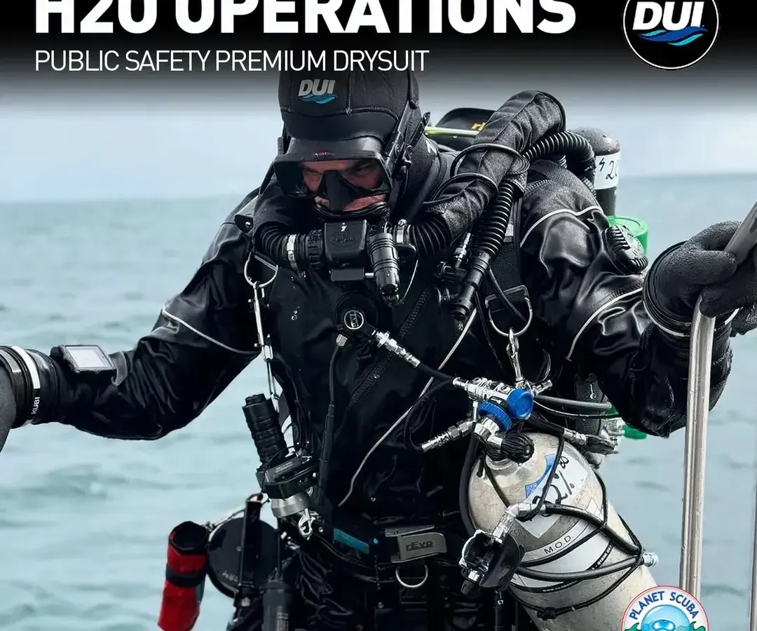 The DUI H2O Operations drysuit is engineered for public safety divers who face the most challenging conditions. This image shows a fully equipped operator, highlighting the suit's integration with tactical gear, its rugged build for hazardous water, and the mobility it provides for critical tasks.