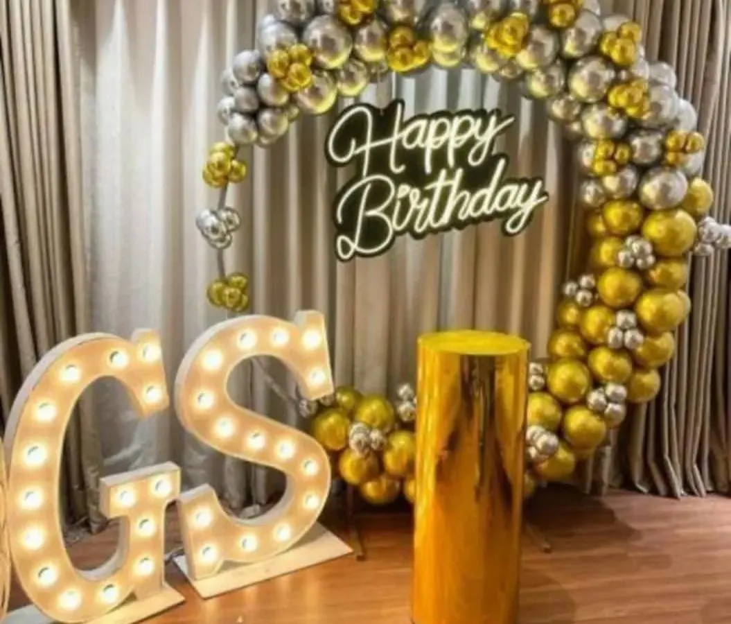 For a truly special birthday, I offer these premium setups. This one includes a full ring of metallic gold and silver balloons, a bright "Happy Birthday" neon sign, and large, light-up marquee letters for the initials. It's a glamorous photo backdrop perfect for milestone birthdays.