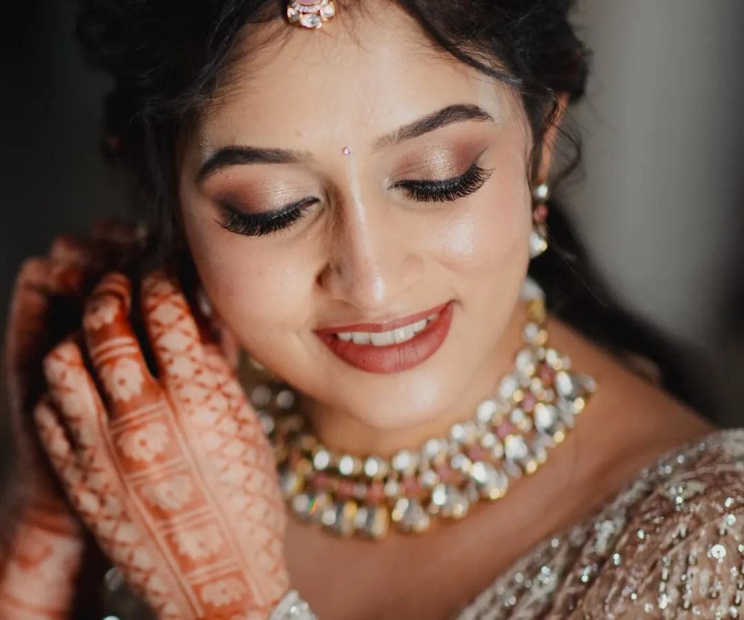 A close-up of a soft glam reception look. I used warm, shimmery eyeshadows and a neutral pink lipstick to create a romantic and modern feel that enhances her natural features without feeling heavy.