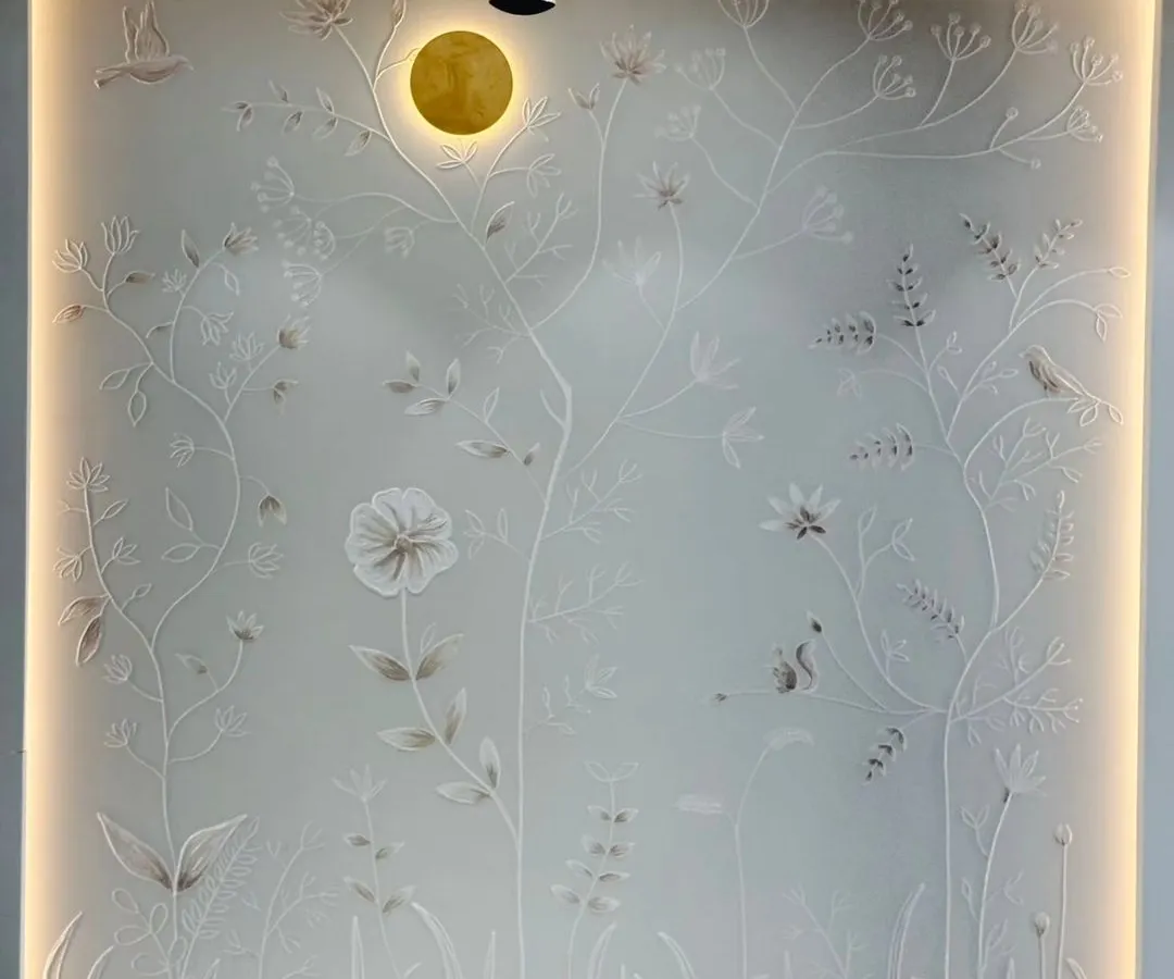Texture adds a layer of depth and elegance that invites you to look closer. This 3D floral mural, created with plaster for a living room, plays with light and shadow to create a subtle yet stunning focal point.