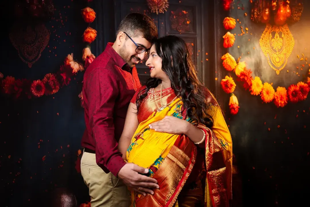 Capturing the warmth and love between partners during this special time. This festive setup with marigold garlands and soft lighting is perfect for celebrating your journey with a traditional touch.