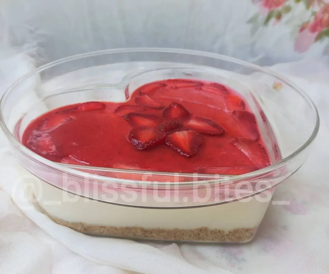 My no-bake fresh strawberry cheesecake, presented in a lovely heart-shaped dish. This dessert is a seasonal favorite, featuring a creamy cheesecake filling and a vibrant topping made with fresh strawberries.
