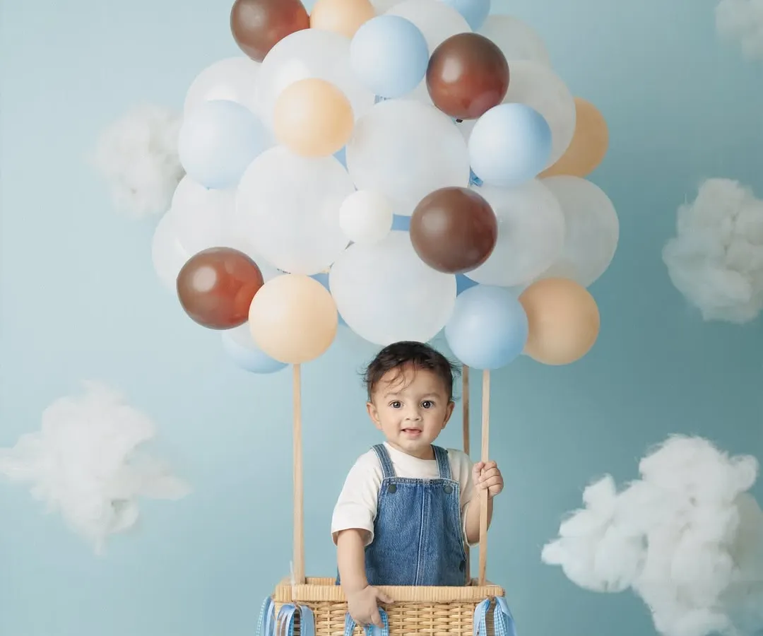 This hot air balloon theme for my son Caden's 8-month milestone was so much fun to create. I love designing unique, playful studio setups for baby photoshoots that capture their budding personalities.