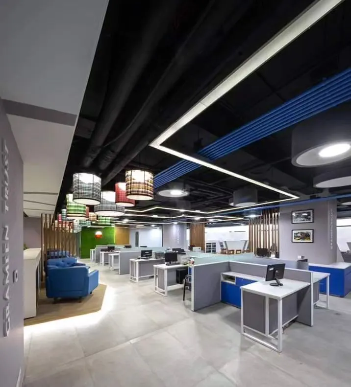 Here is a look at a complete open-plan office I designed. The layout includes modular workstations for focused tasks, a comfortable breakout area with the blue sofa for informal meetings, and carefully planned lighting to create a productive atmosphere.