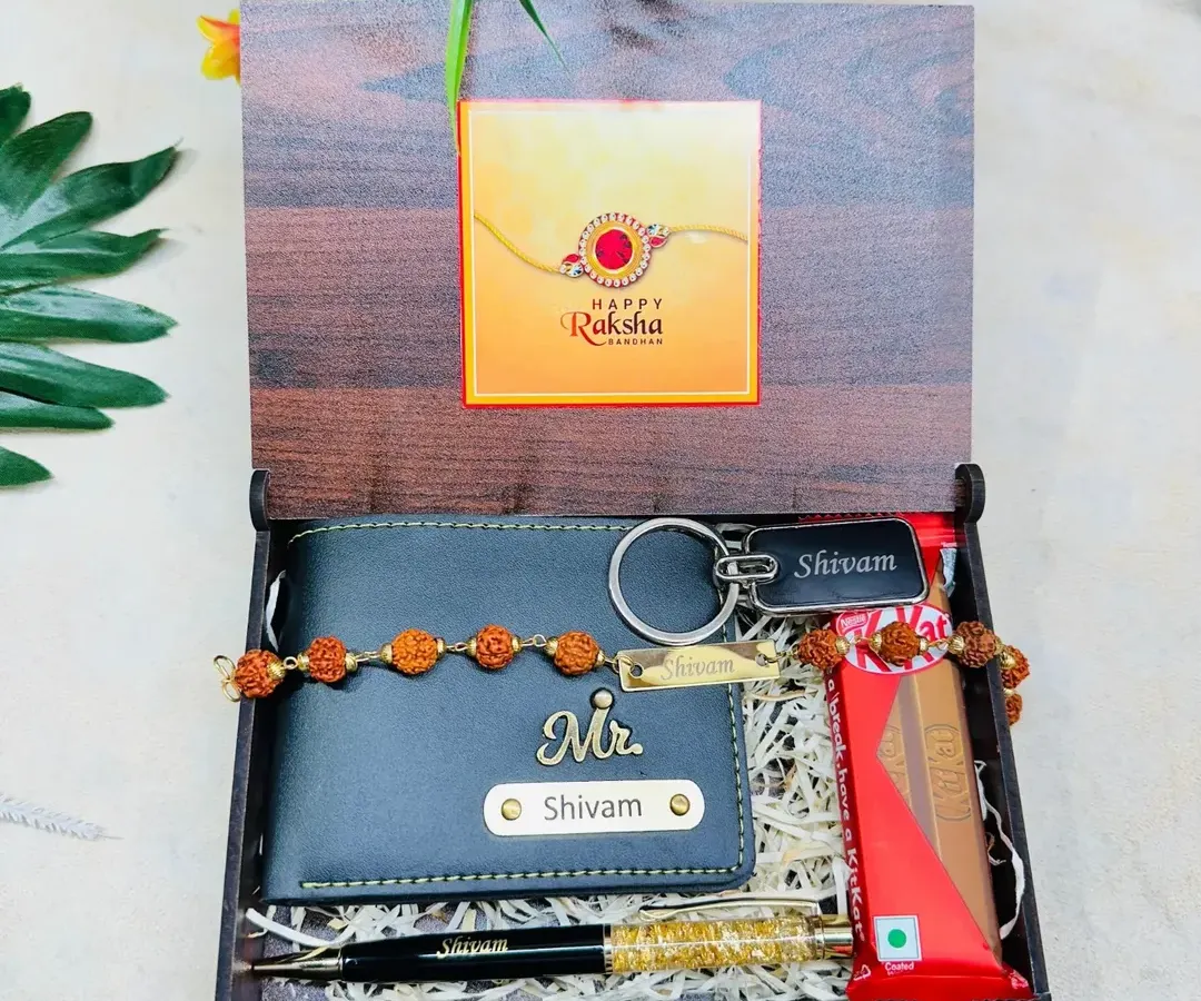 Here is a complete Rakshabandhan gift hamper for a brother. It features a custom wooden box with a photo, containing a personalized wallet, a name-engraved rakhi, a pen, a keychain, and a chocolate bar.